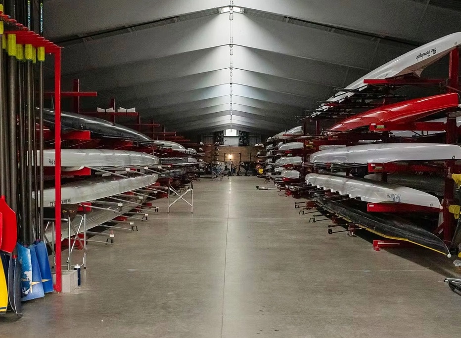 Racing shells stored on racks inside the White Rock Boathouse