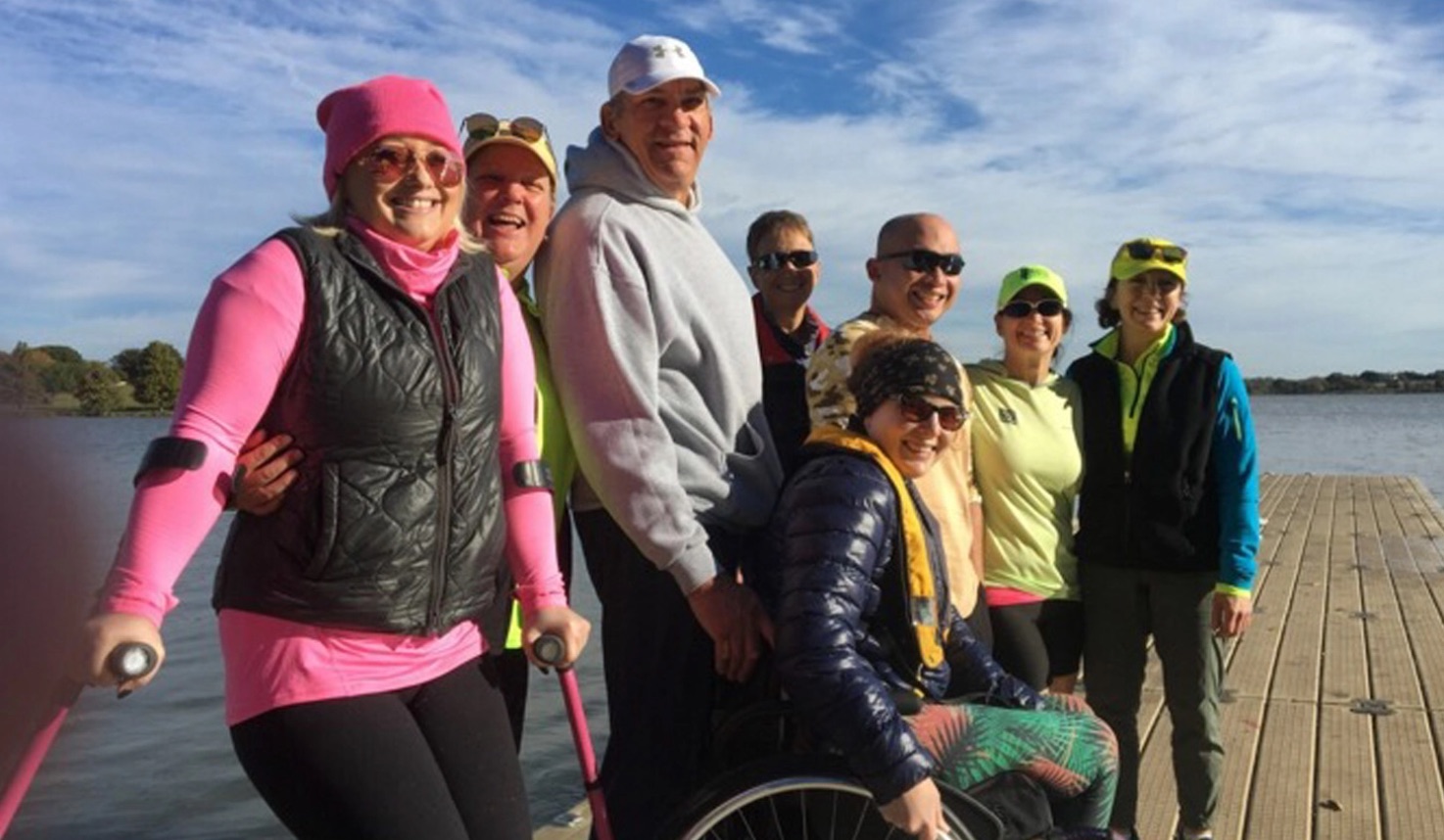 Adaptive and masters rowers gathered together on the dock at White Rock Lake